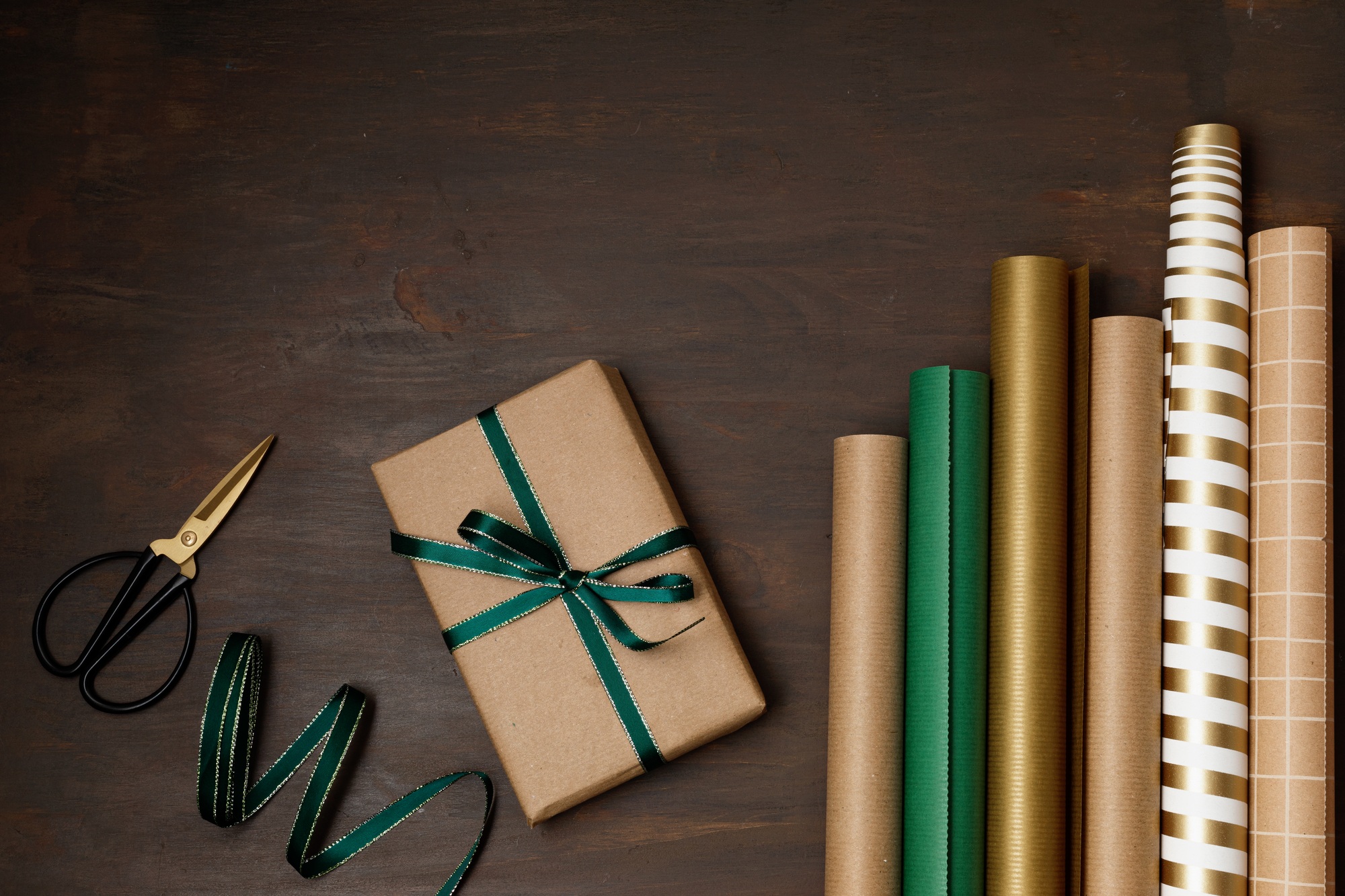 Christmas background with gift boxes and rolls of wrapping paper