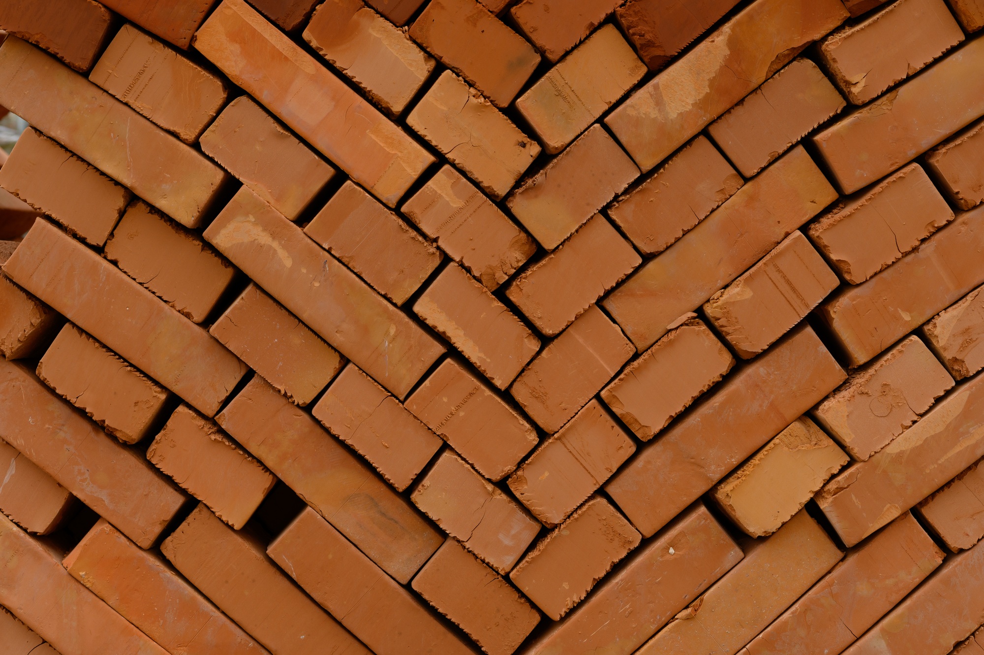 pallets and packages of freshly produced red bricks